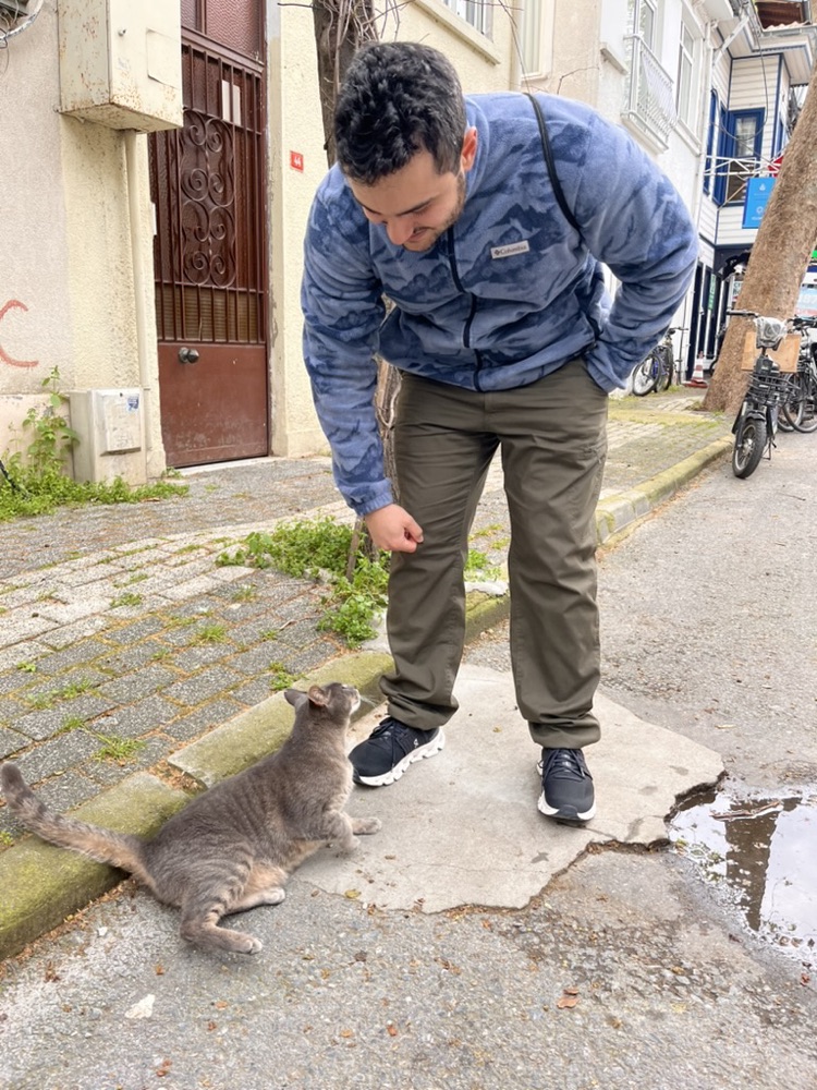 Kaveh greeting a street cat